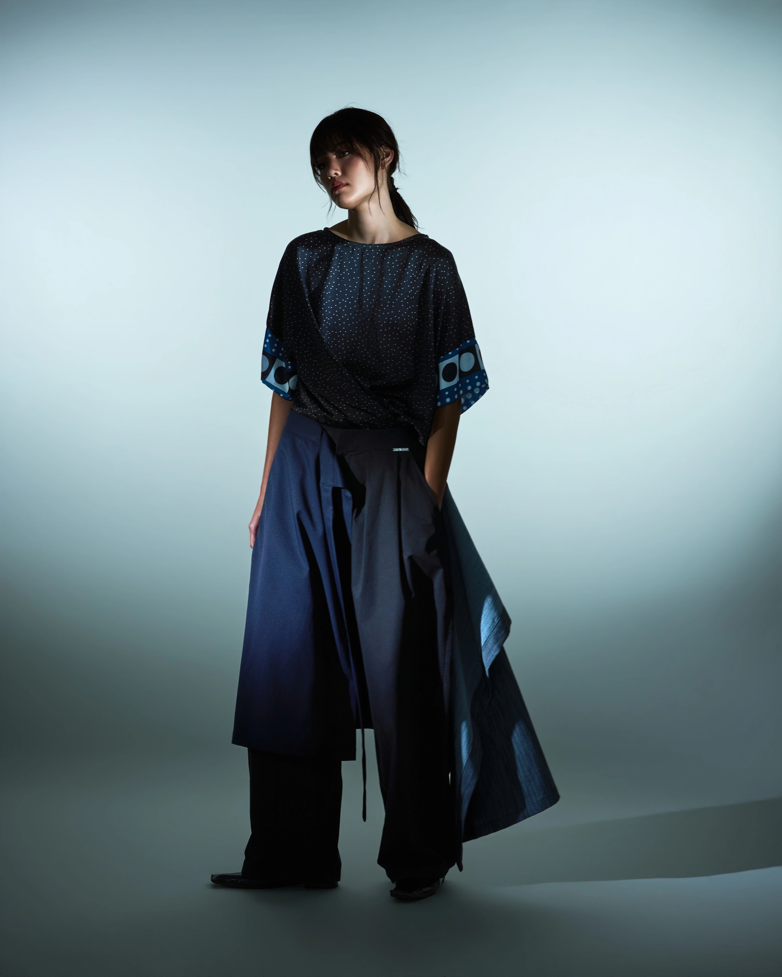 RAJO Holiday 2026 loose blouse with asymmetrical navy trousers